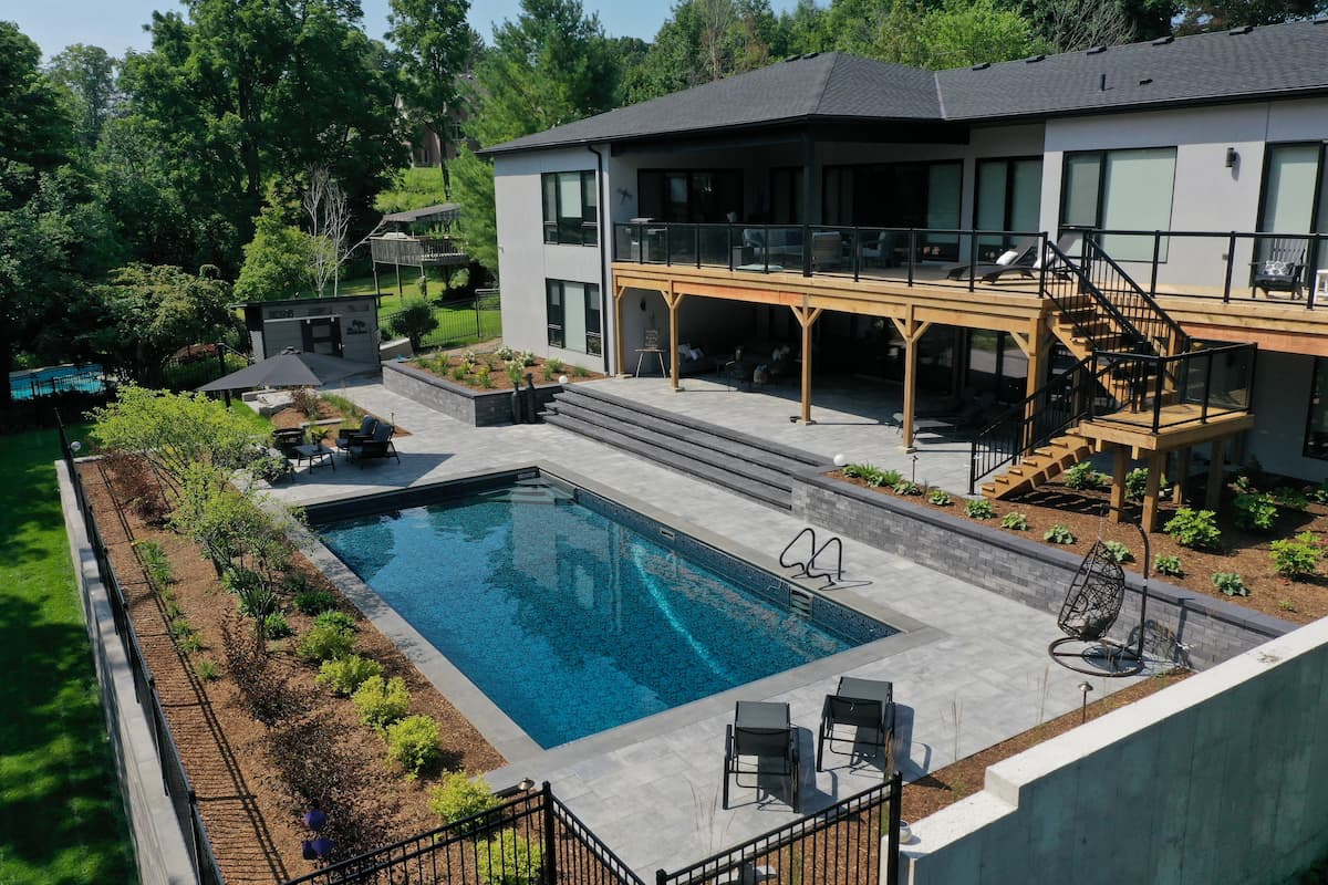 Pool with backyard seating and deck