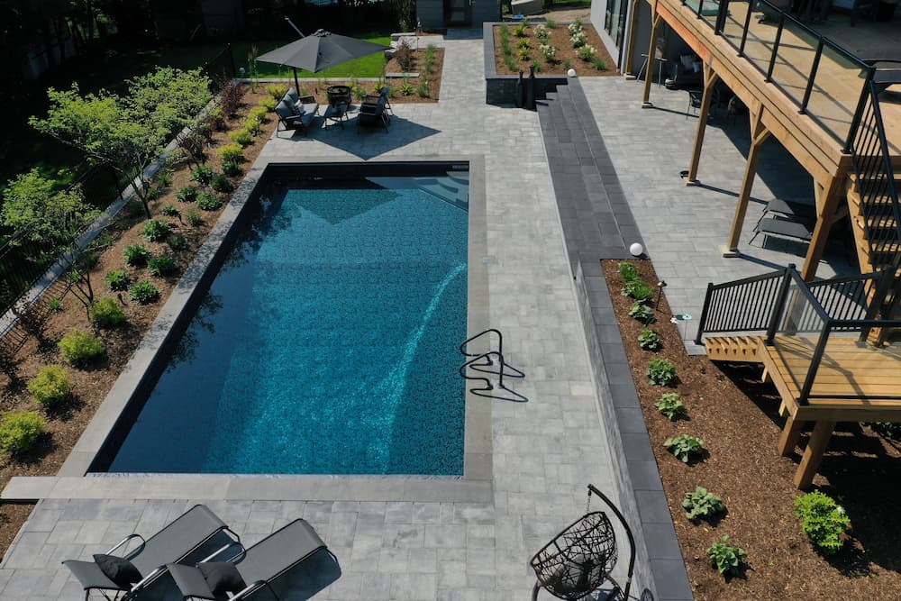 Overview of backyard with pool, garden, and deck.